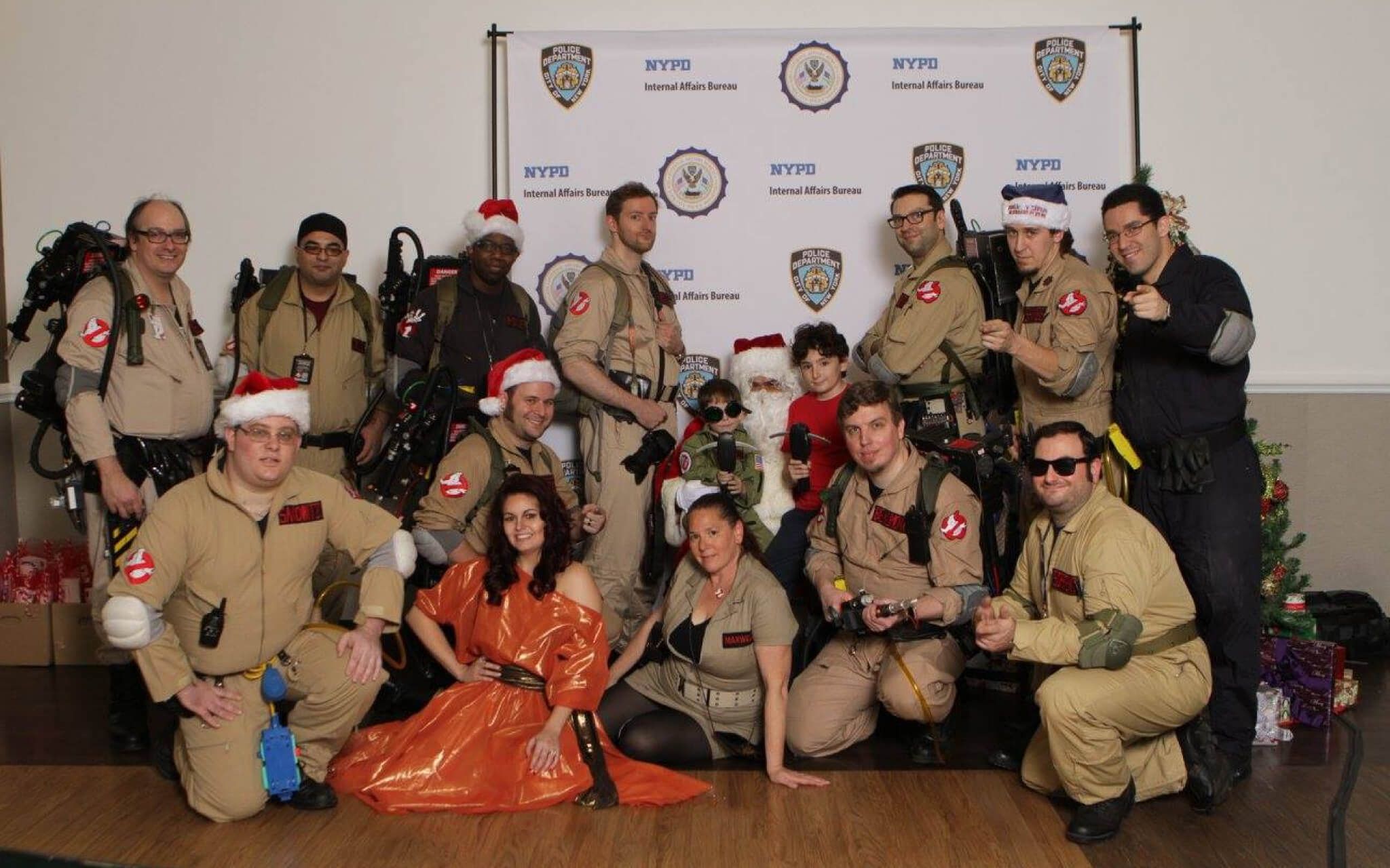 NYC Ghostbusters taking pictures with Santa Claus.